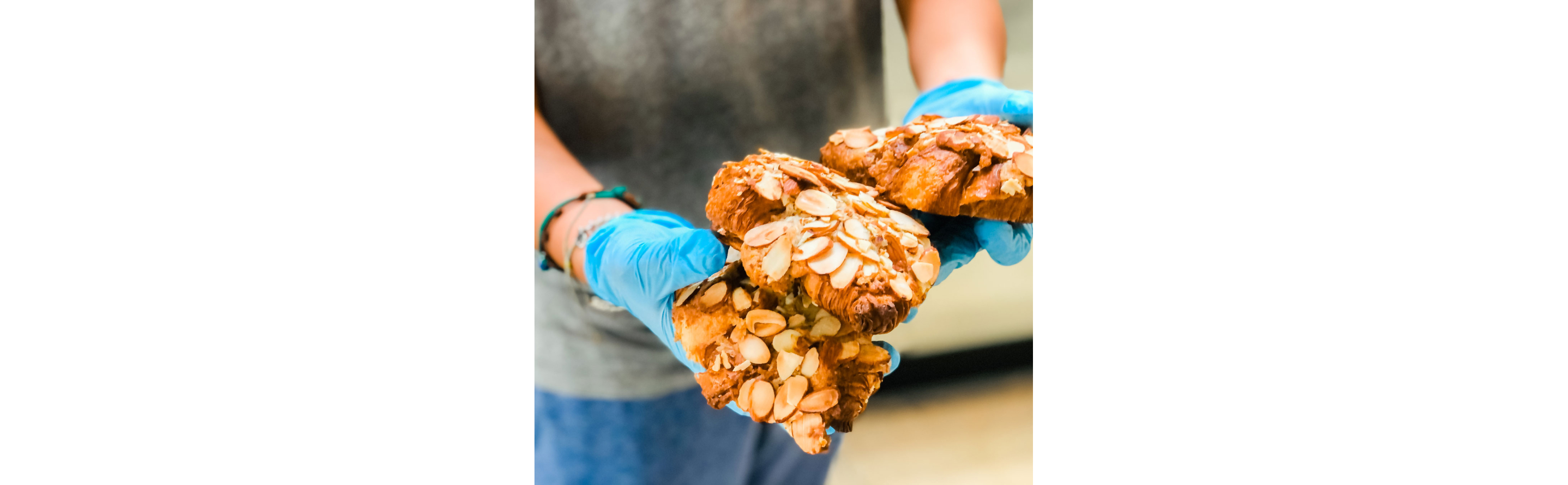 A person holding baked goods from Clark Street Bakery.