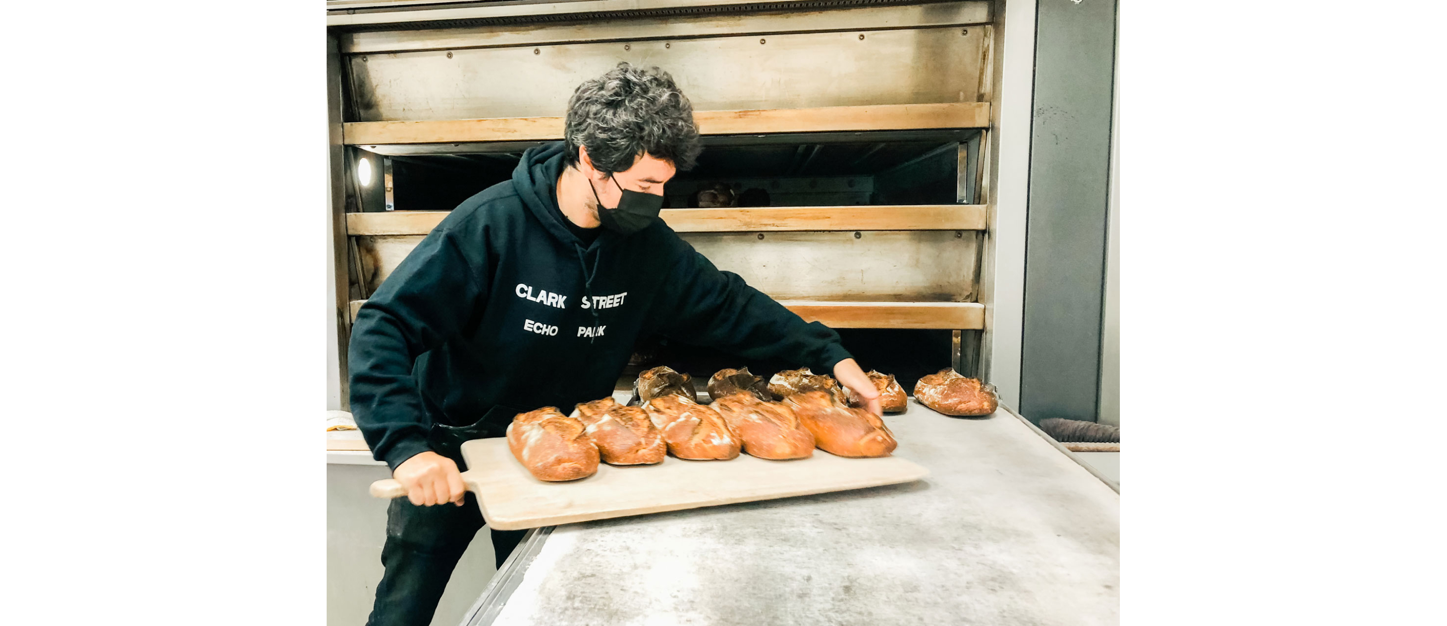 Zach Hall pulling out freshly baked bread.