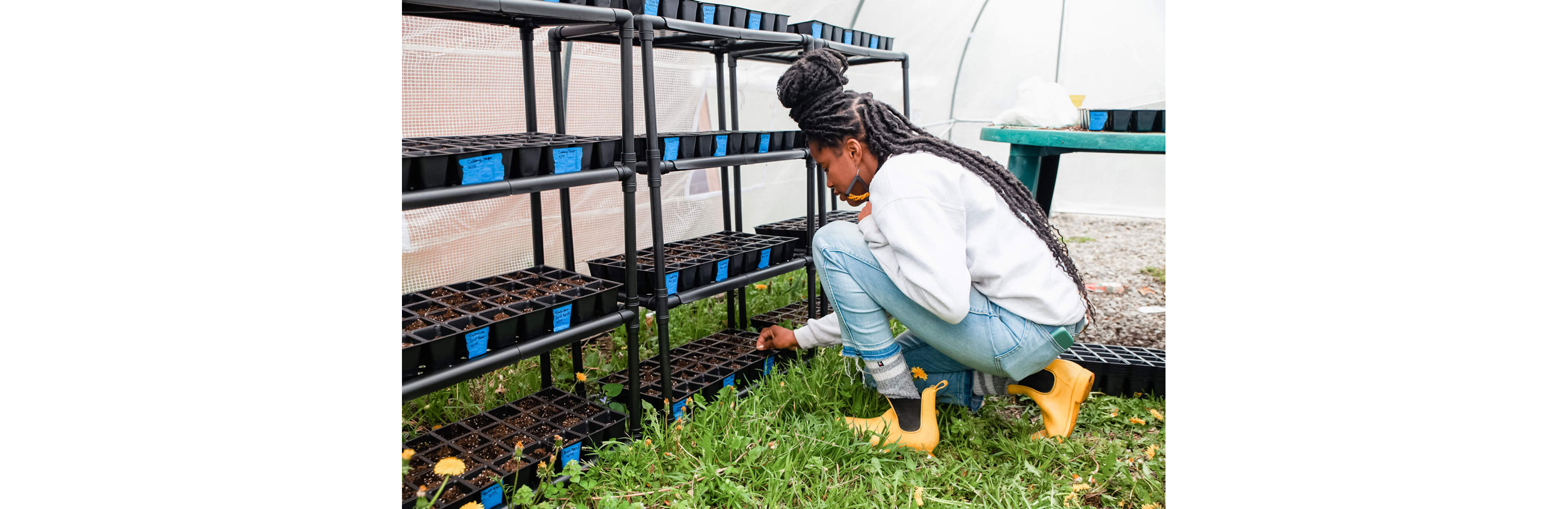 Christa tending to her nursery plants.