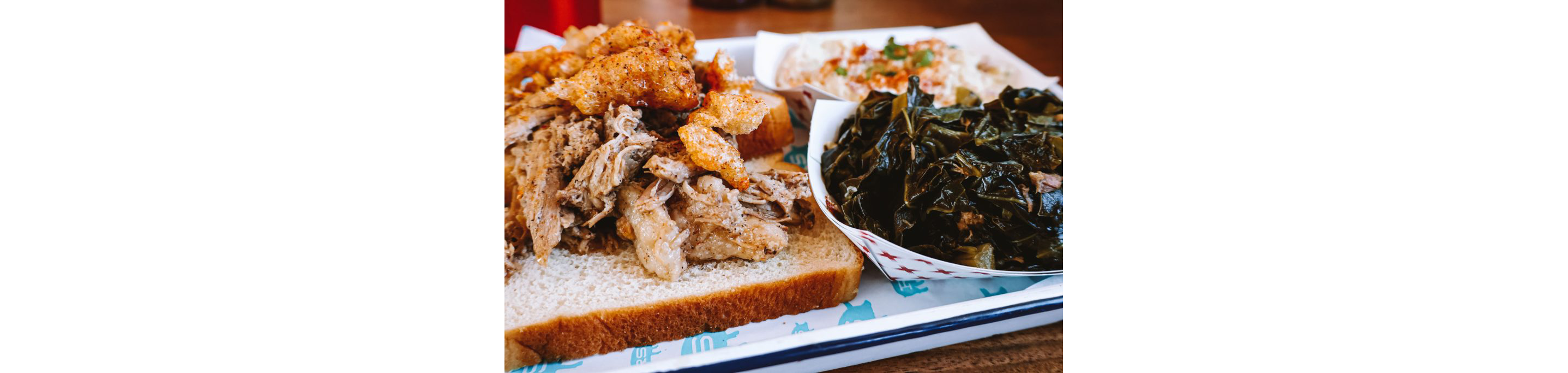 A metal tray topped with barbecue from Rodney Scott's BBQ.