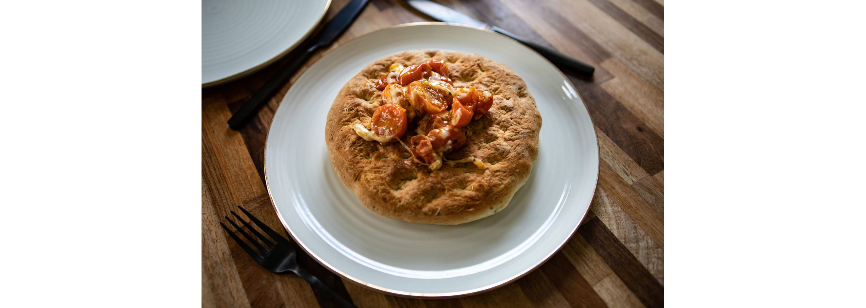 A plated, freshly made focaccia bread.