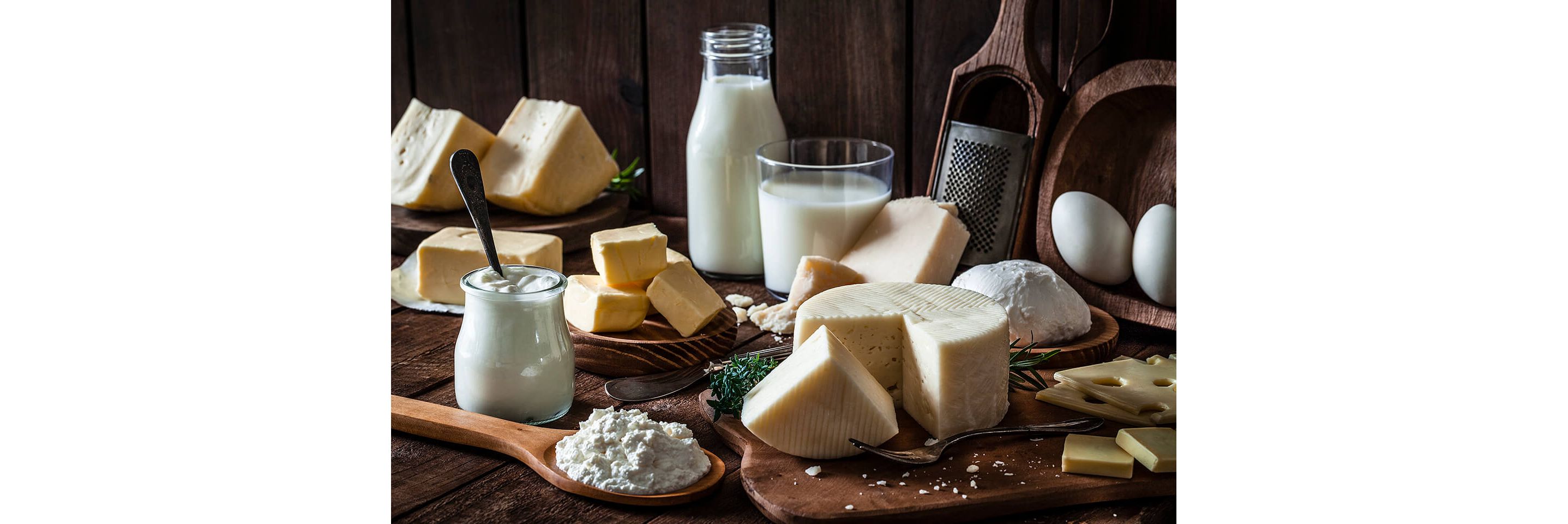A rustic display of a variety of cheeses, creams and other assorted dairy products.