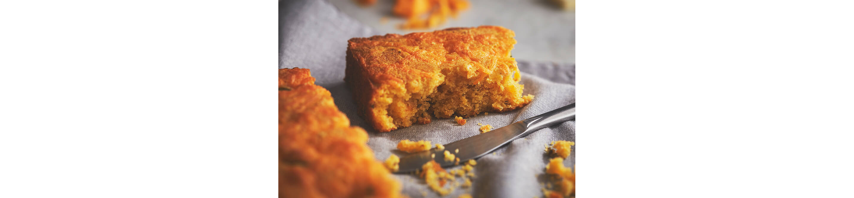 A slice of cornbread resting on a cloth napkin.