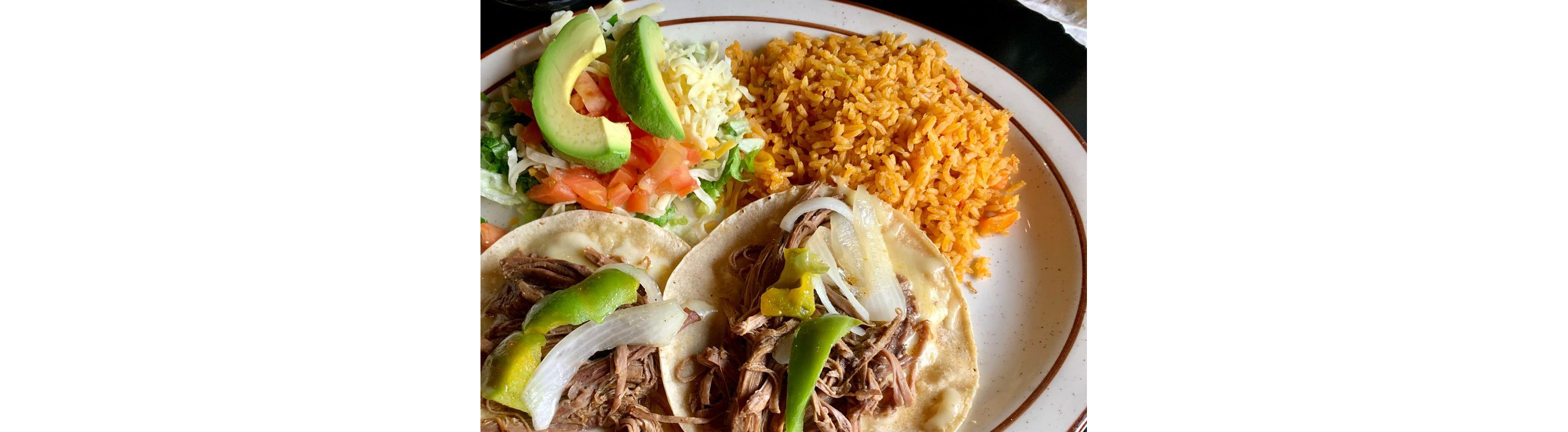 A full plate of shredded meat tacos, Mexican rice and a small salad.