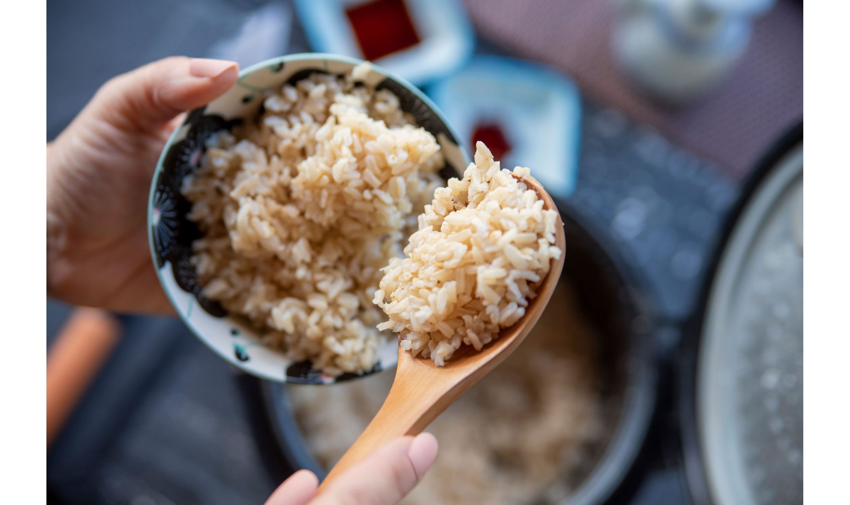 A white bowl with intricate blue detailing filled with cooked rice.