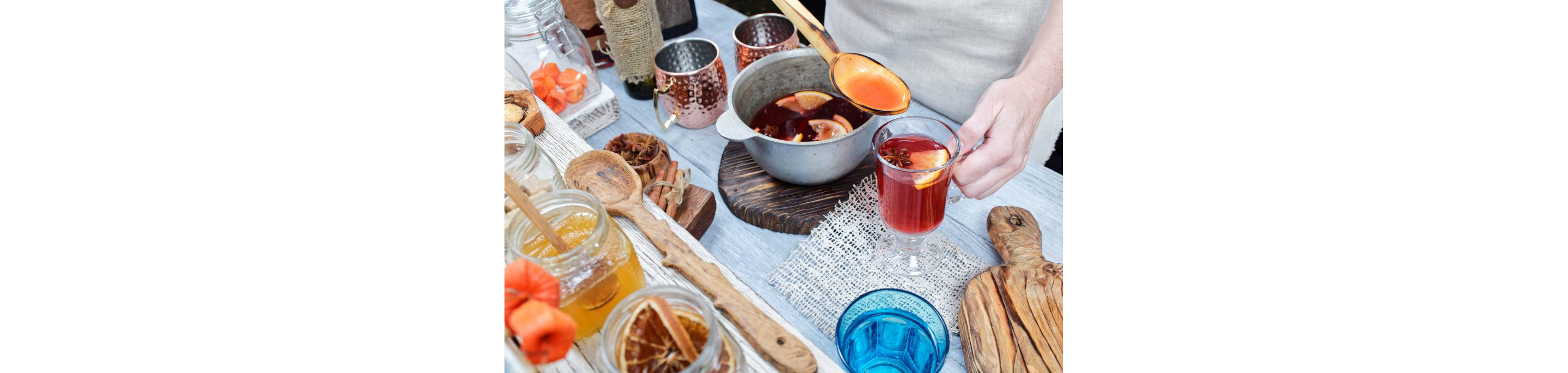 A person serving Austrian gluhwein, mulled red wine with cinnamon, star anise, vanilla and citrus.