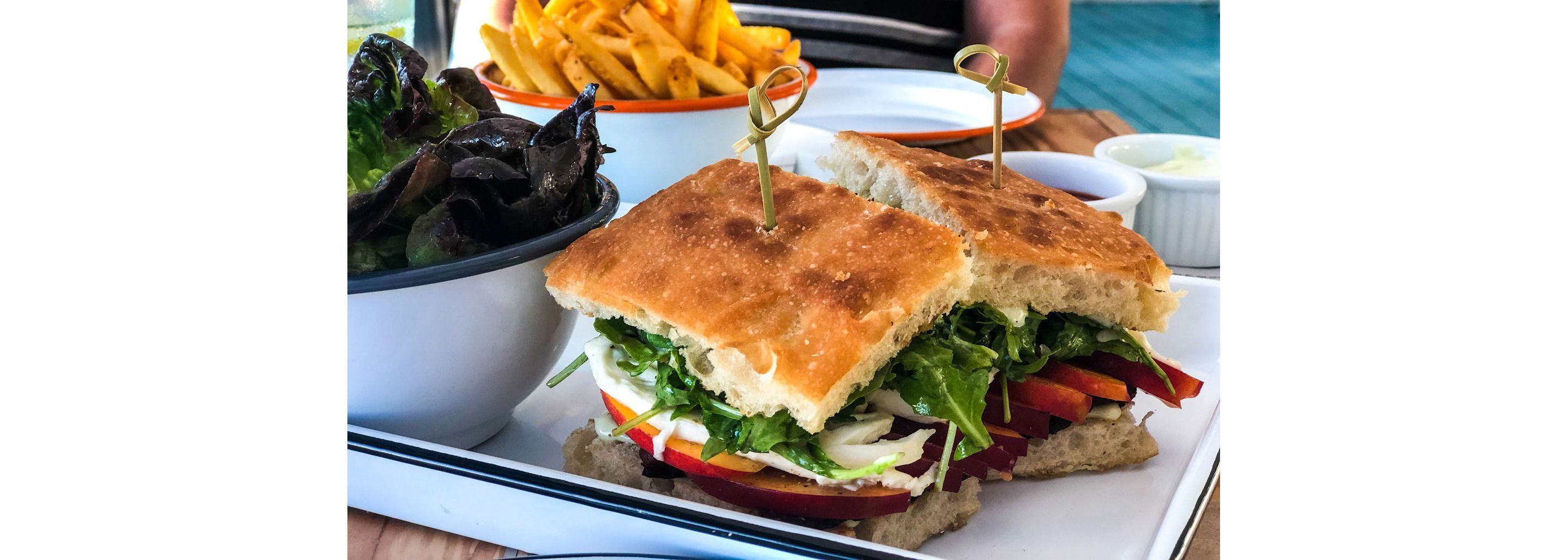 A fresh sandwich paired with a side salad.