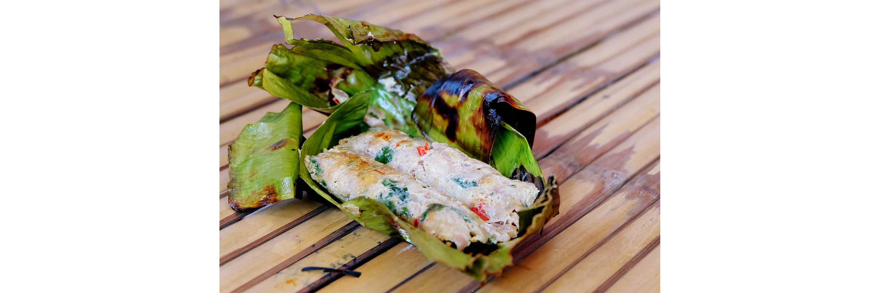Freshly steamed chimaki unraveled on a table.