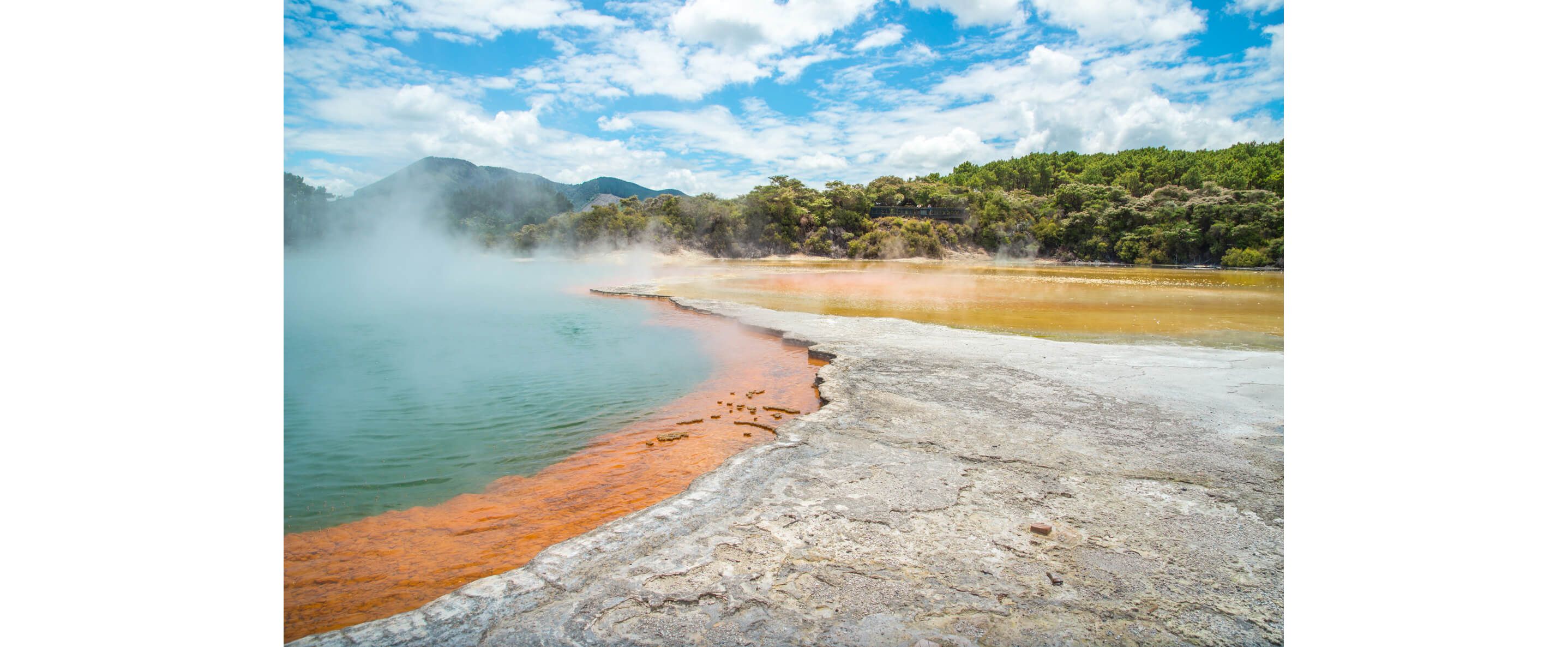 Natural hot springs of New Zealand under a sunny sky.