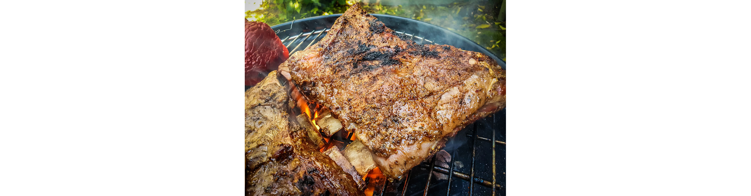 Ribs cooking on a grill.