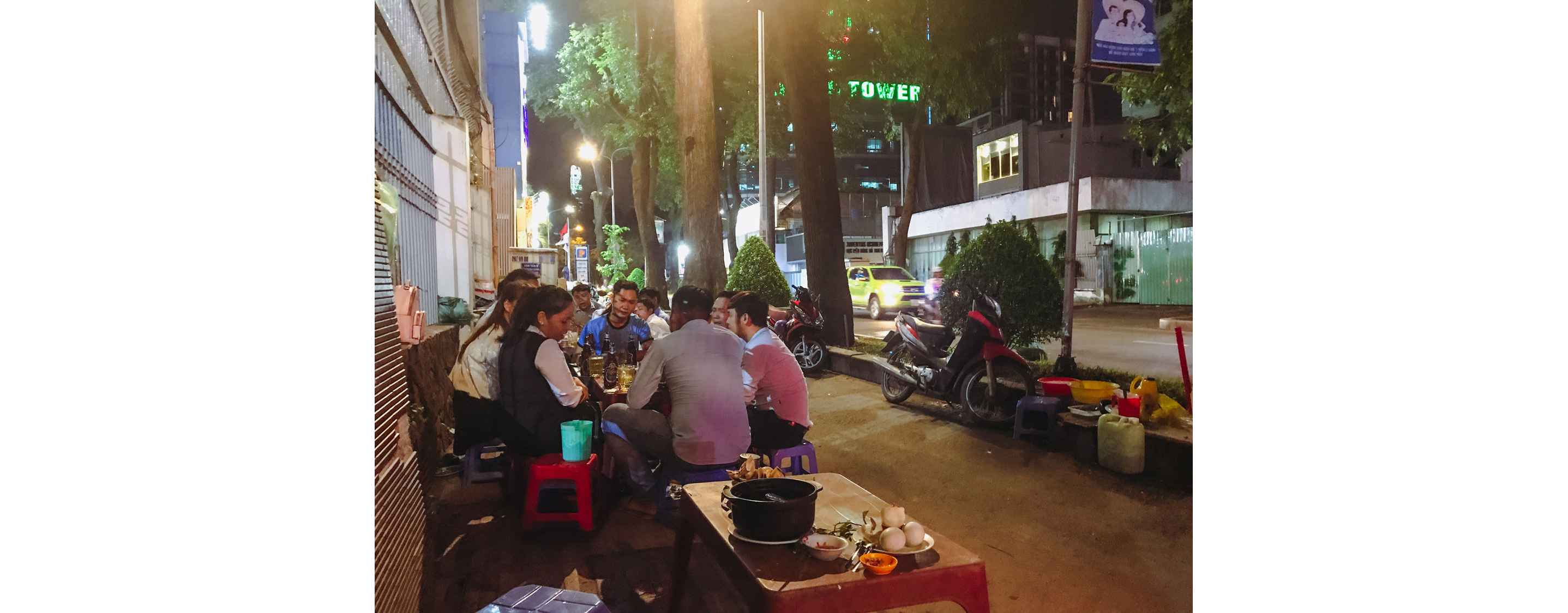 People sitting outside eating their food and socializing.
