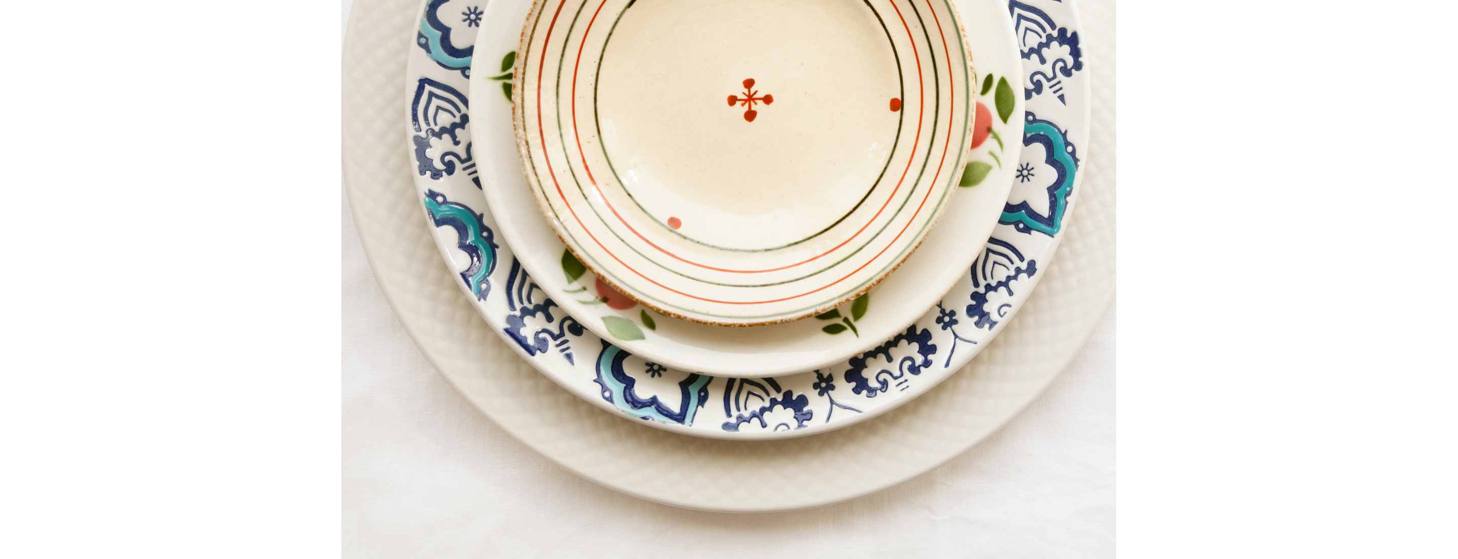 Stack of colorful, mismatched plates