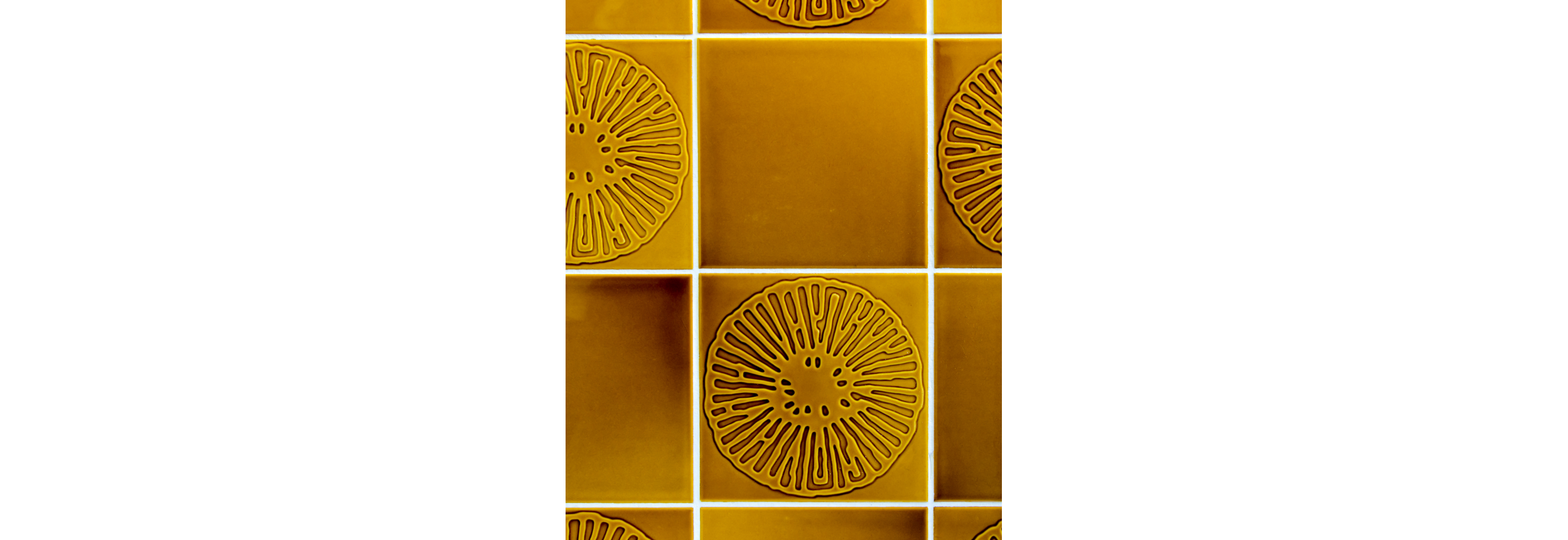 Tile with a warm color scheme and floral etched design