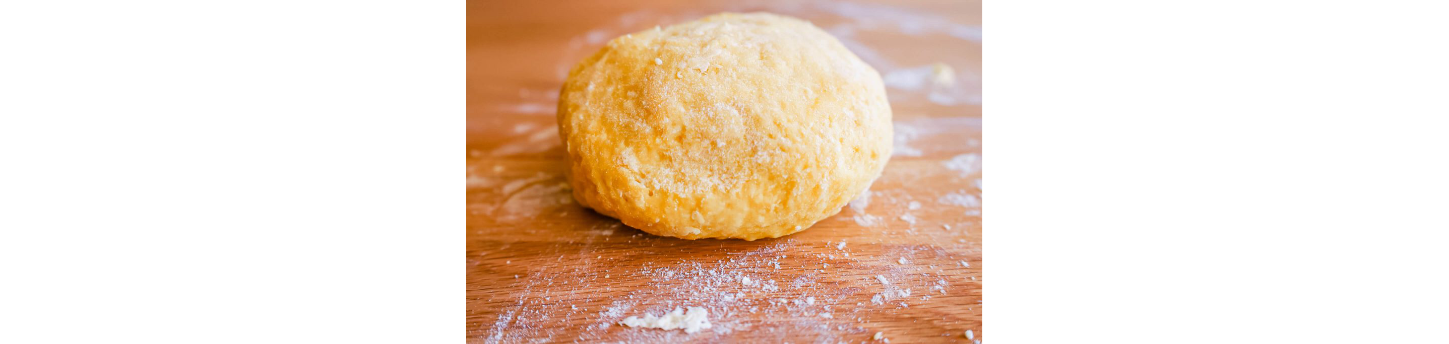 A ball of dough sprinkled with flour.
