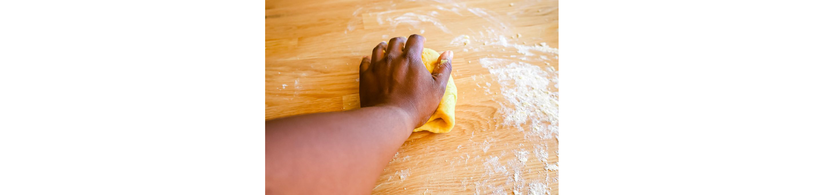 A hand working a ball of dough.