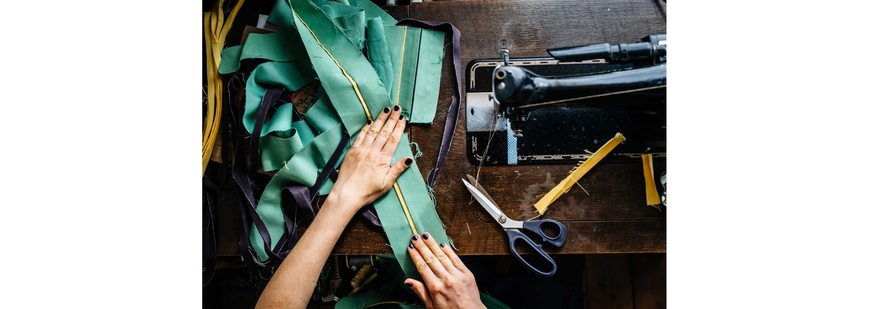 Determined hands smoothing out fabric to be sewn.