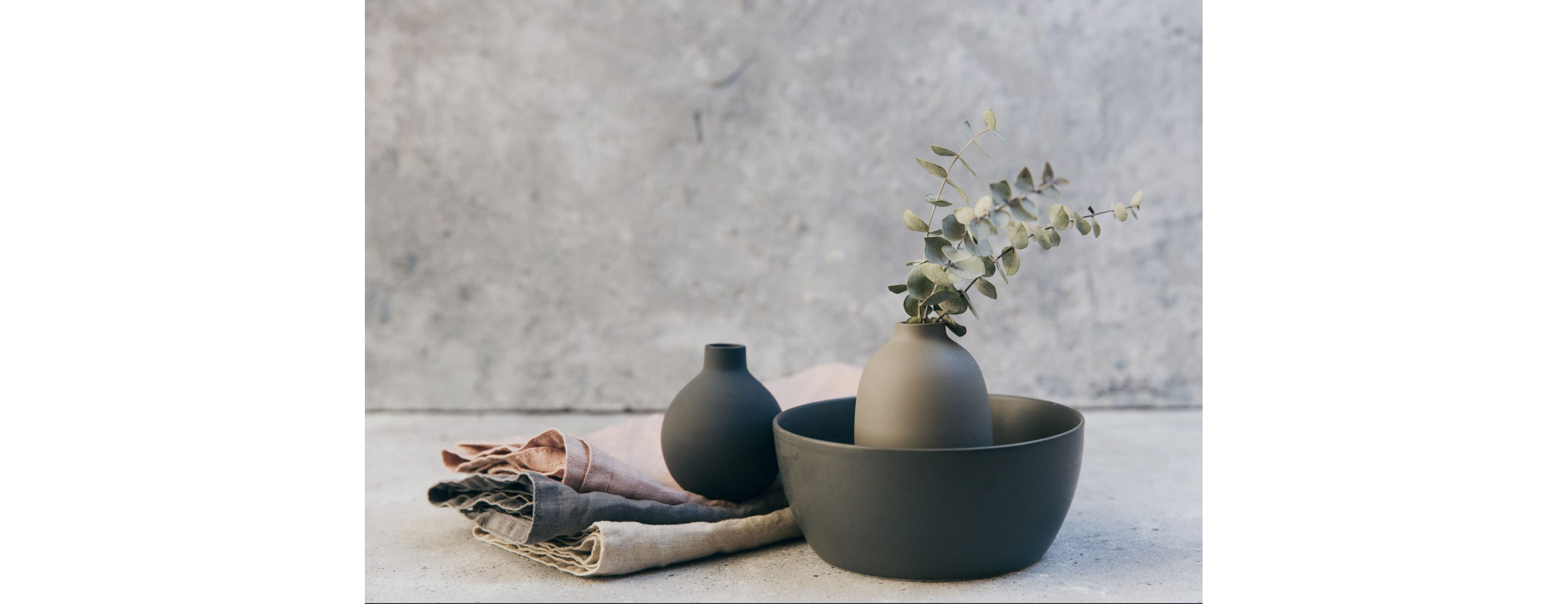 Pottery and linens in muted tones.