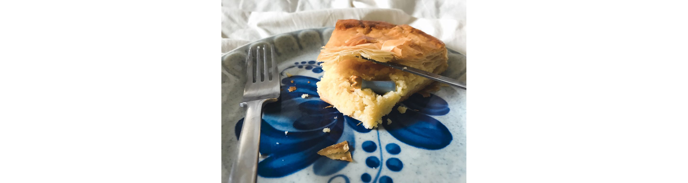 A porcelain fève resting inside a slice of galette des rois.