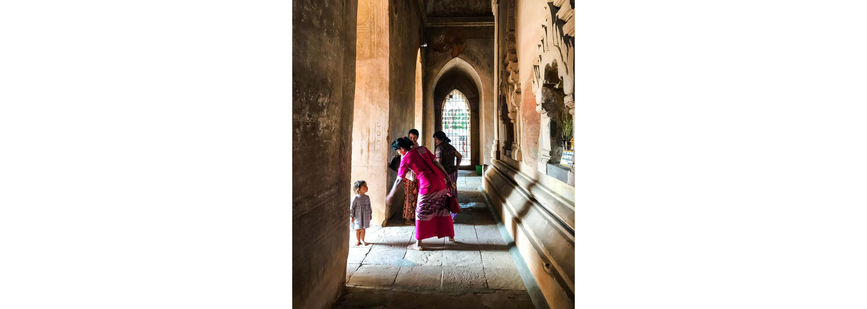 People barefoot in a temple in Myanmar.