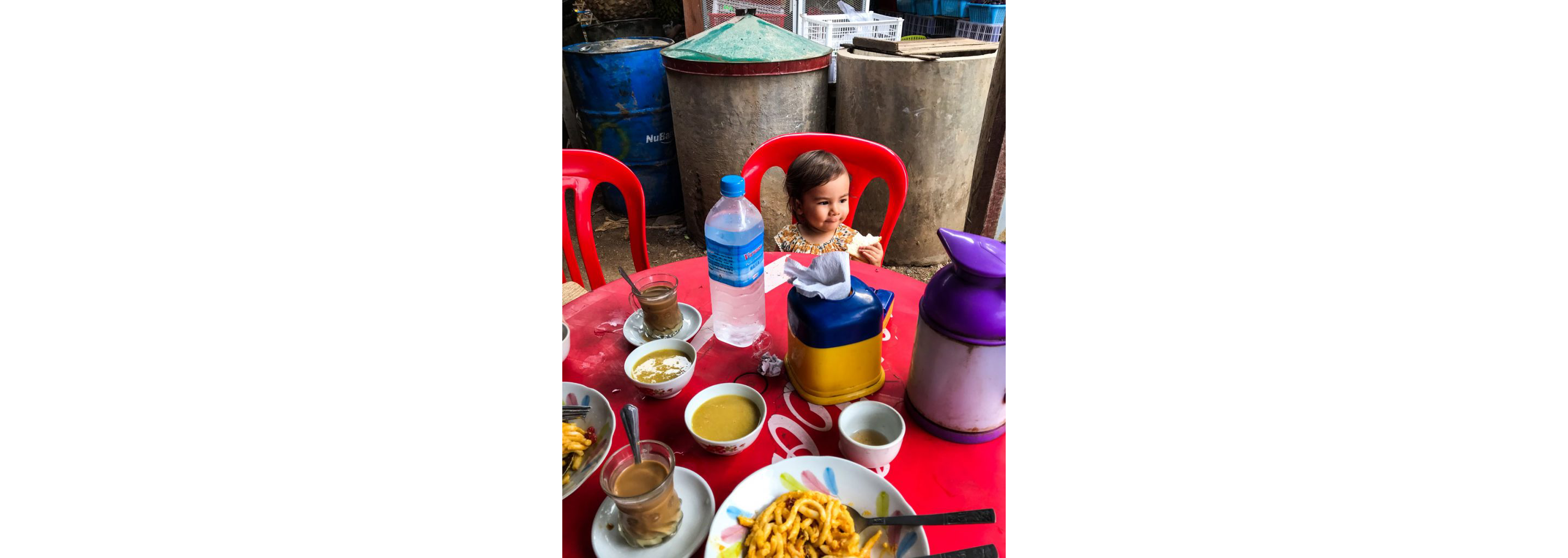 Wee Ling Soh's young daughter eating a piece of bread for lunch.