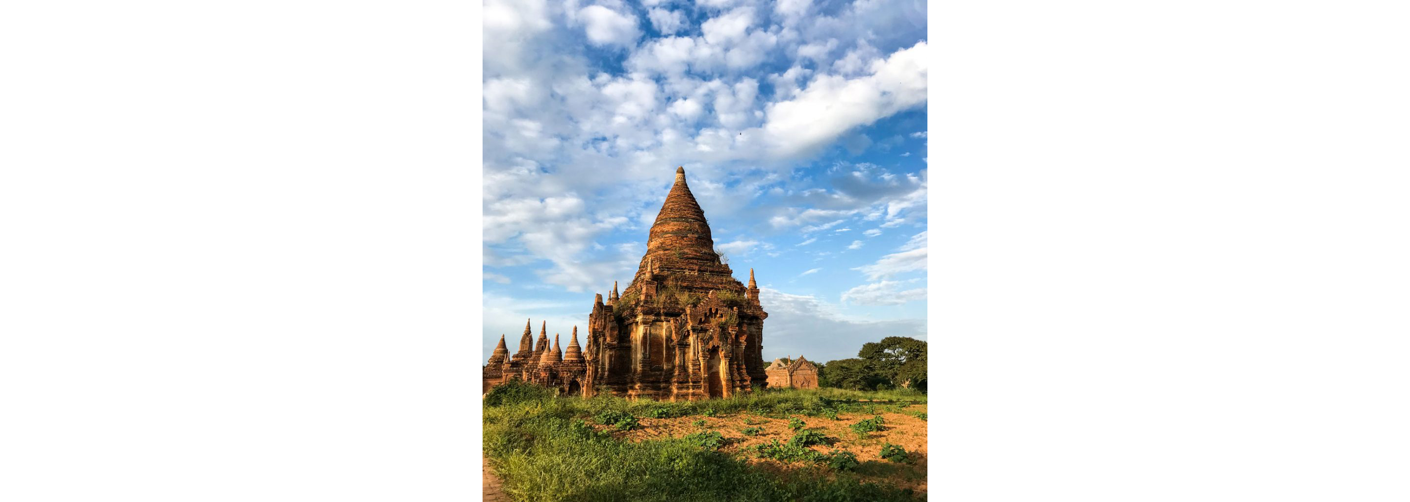 A view of ancient brick temples in Myanmar from a cart being pulled by a horse.