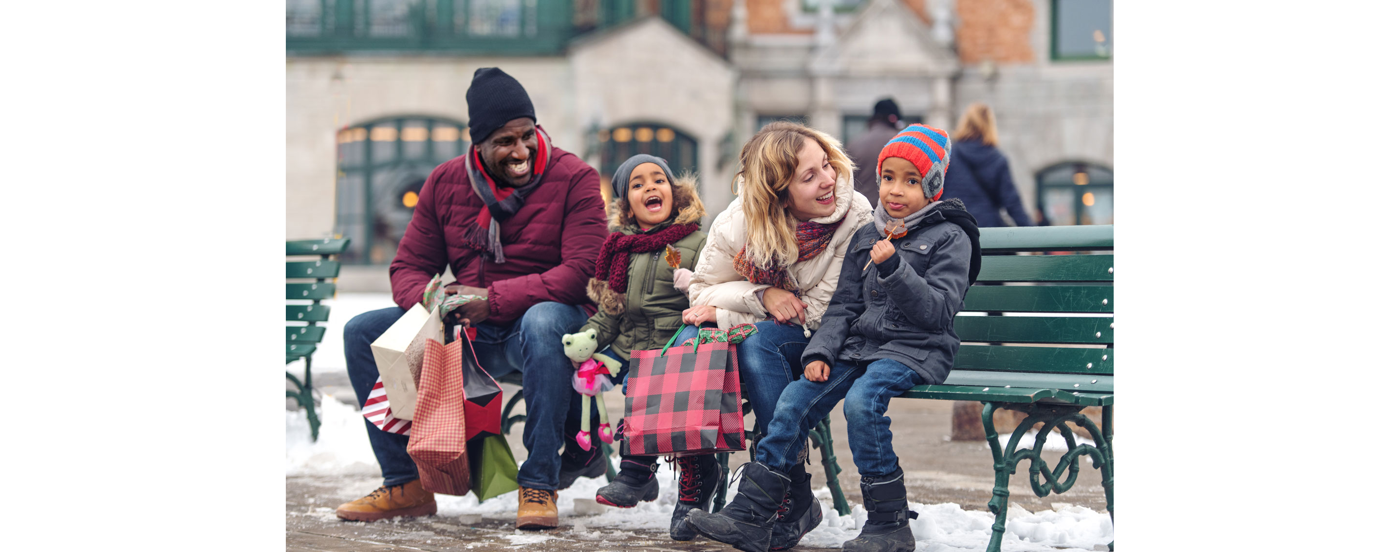 A family sitting on a bench.
