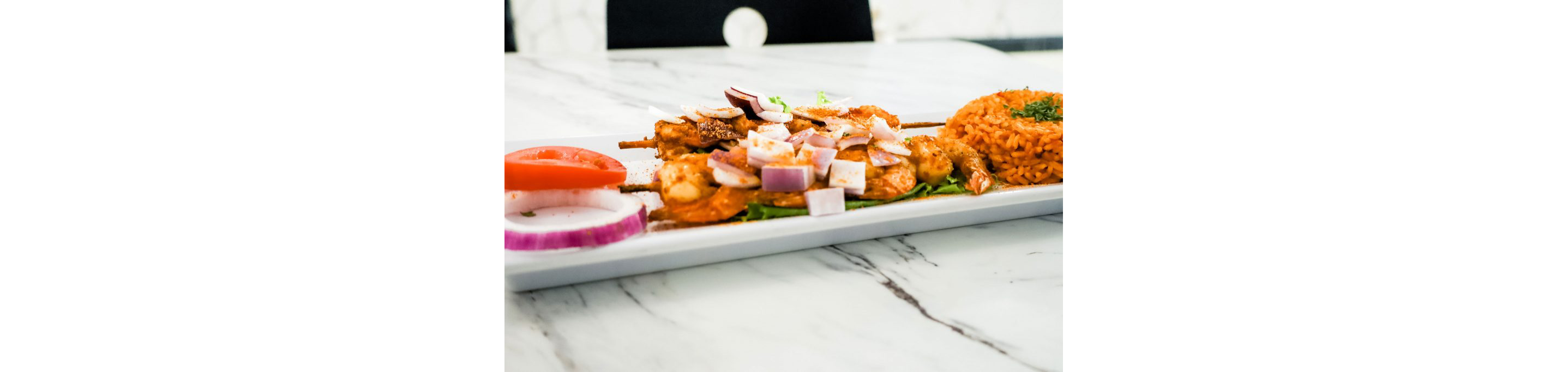 A close up of grilled shrimps on skewers.