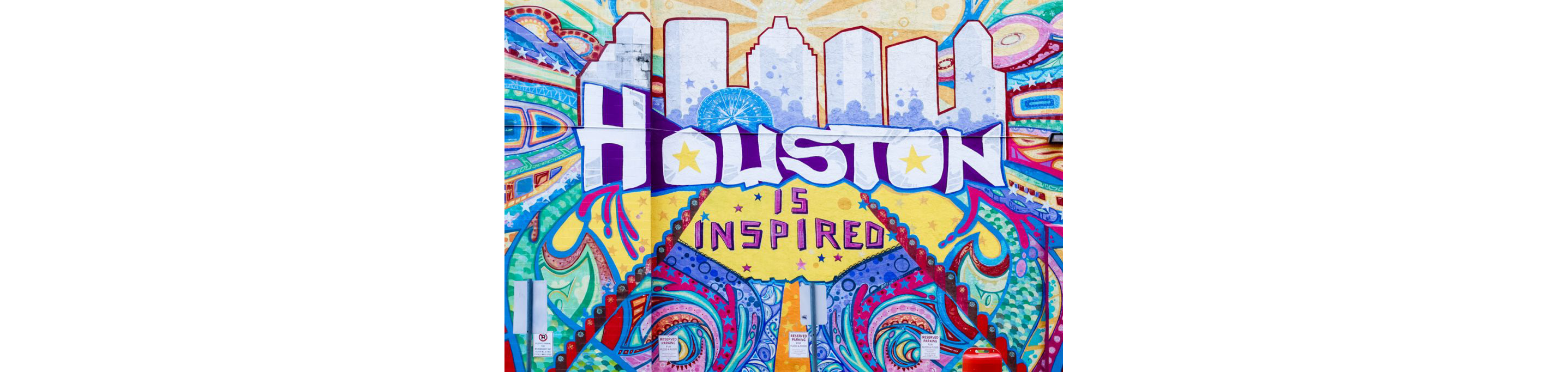 A large, colorful mural that reads Houston is inspired.