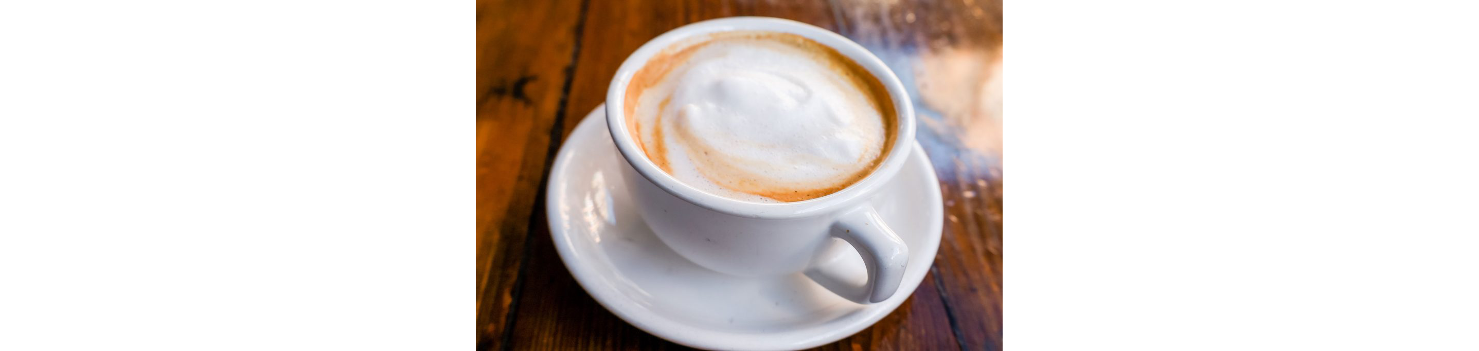 A chai tea latte in a tea cup.