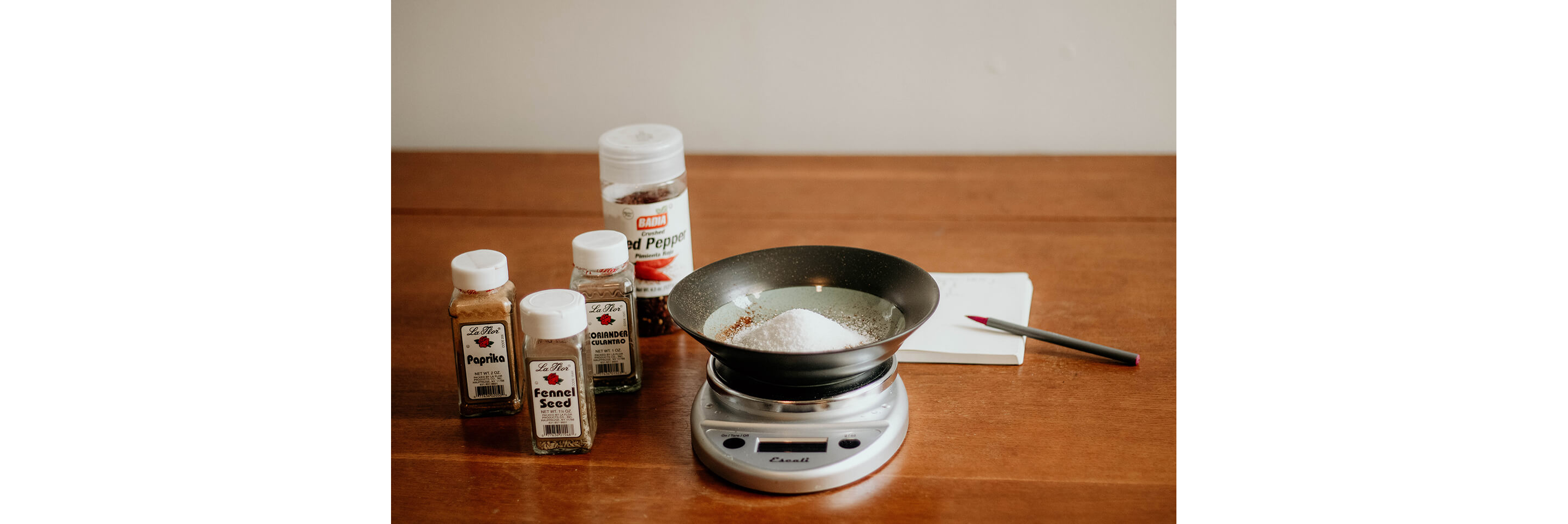 A food scale measuring a variety of seasonings.