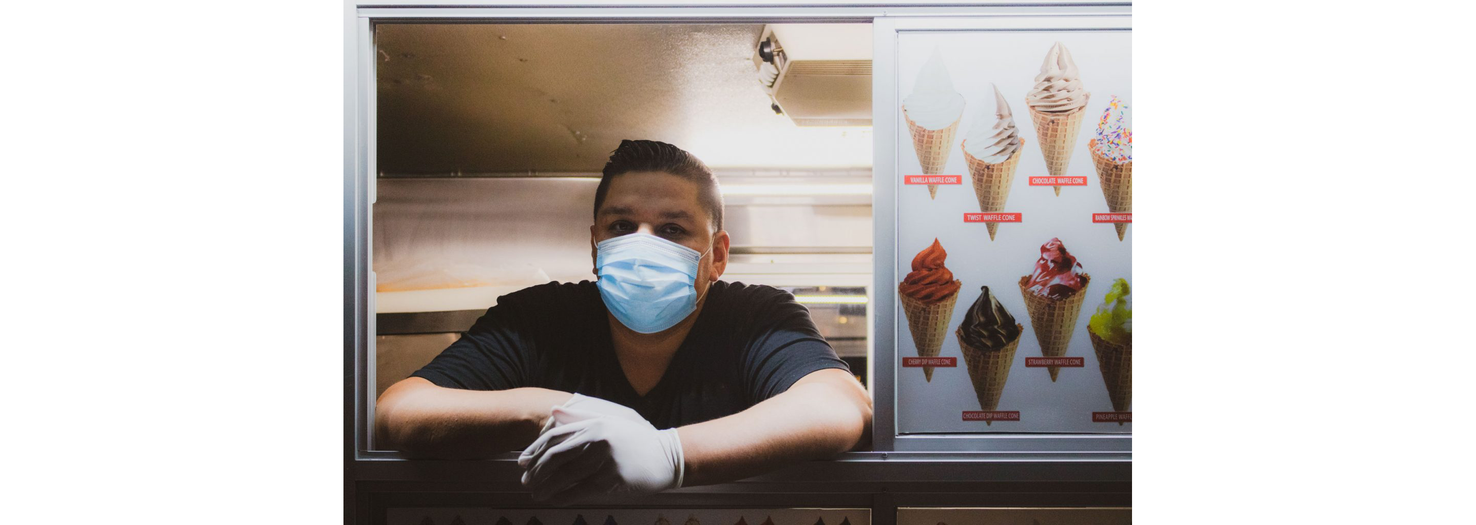 Andy Alvarez patiently waiting for customers inside his ice cream truck.