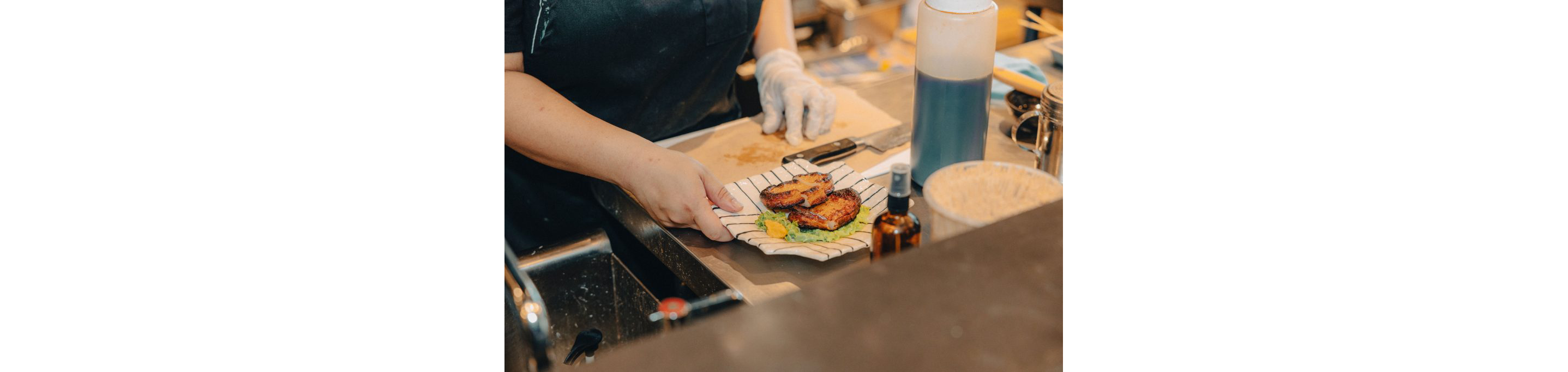 A person holding a small Japanese dish.