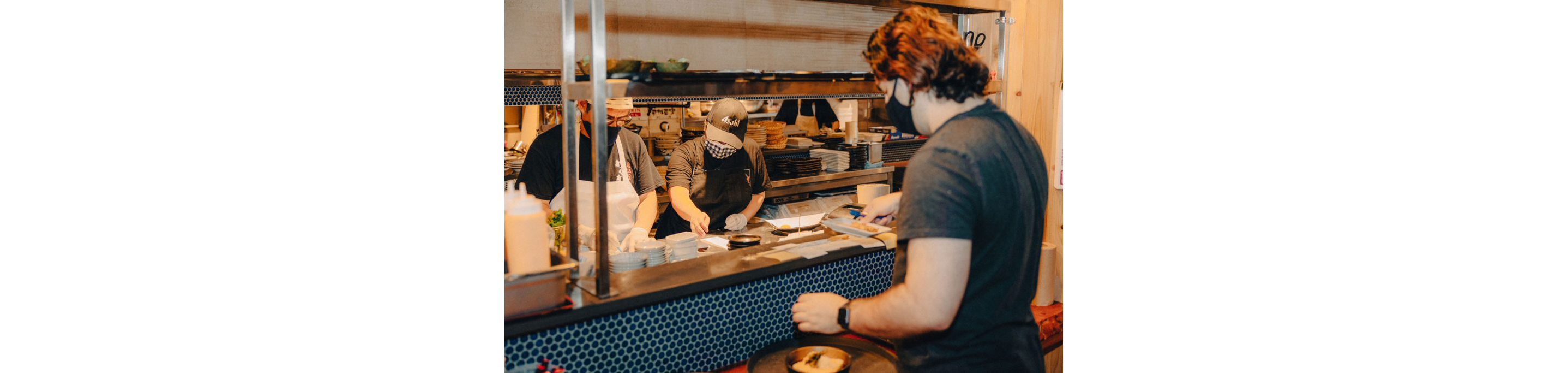 A person taking orders from the kitchen.