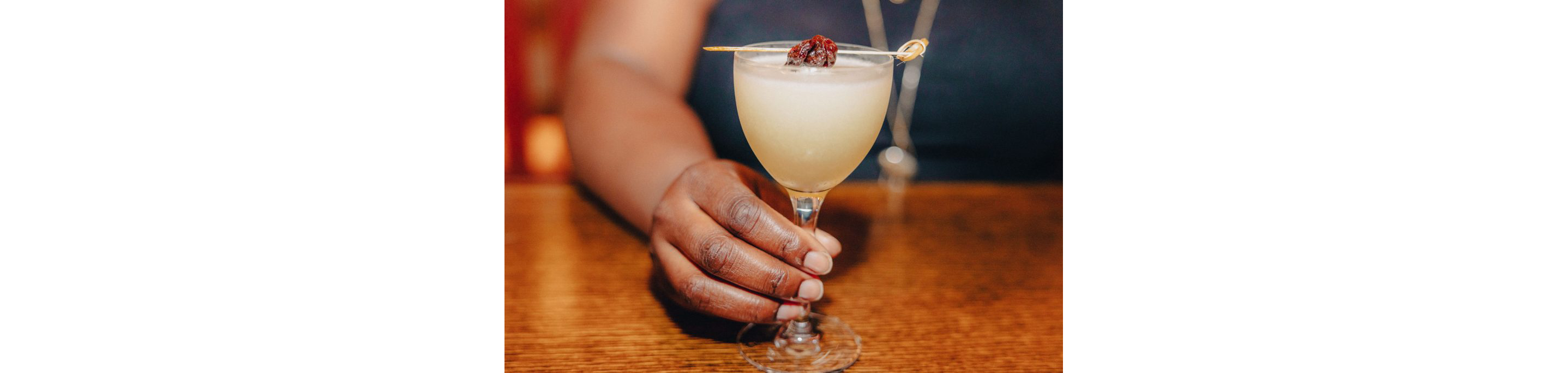 A person holding a Japanese cocktail.