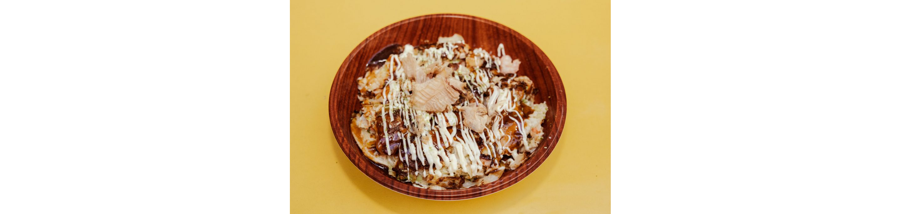 A Japanese dish set in a large wooden plate.