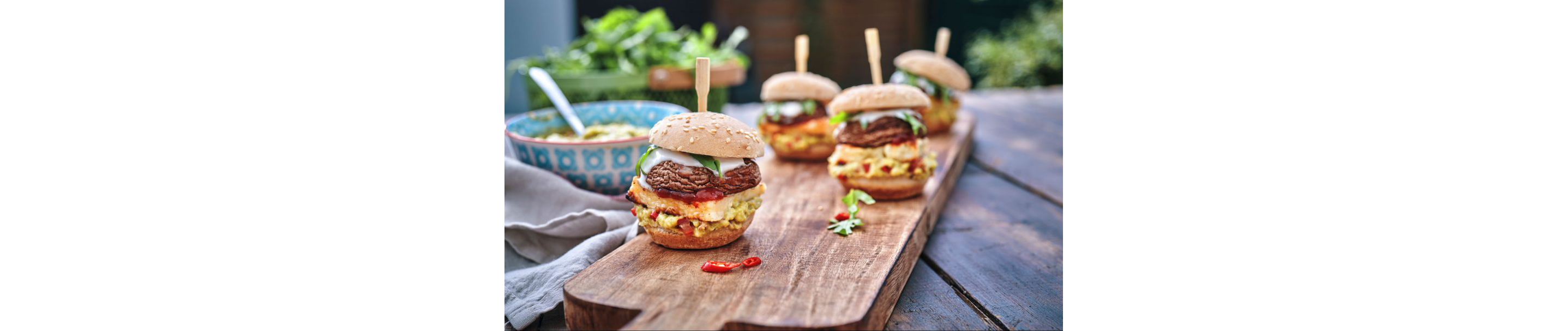 Delicate portobello mushroom burgers served on a wooden board.