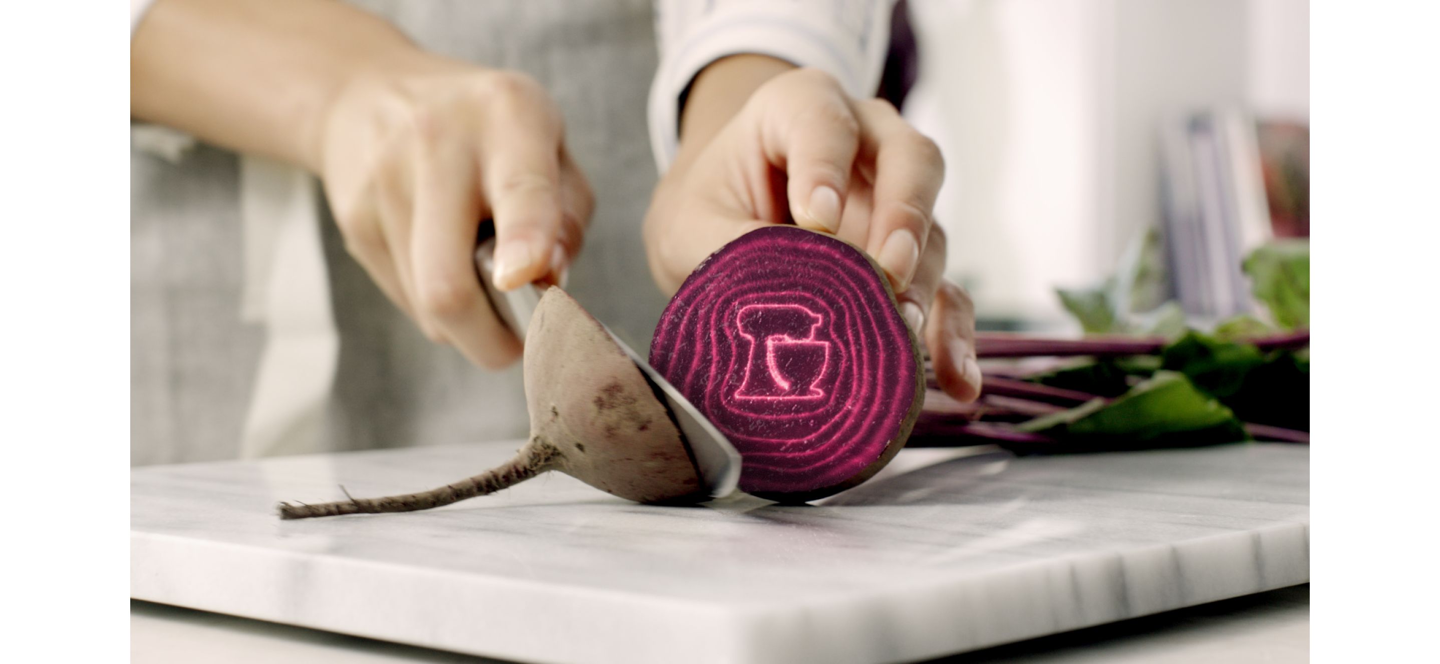 A person cutting into a beetroot.