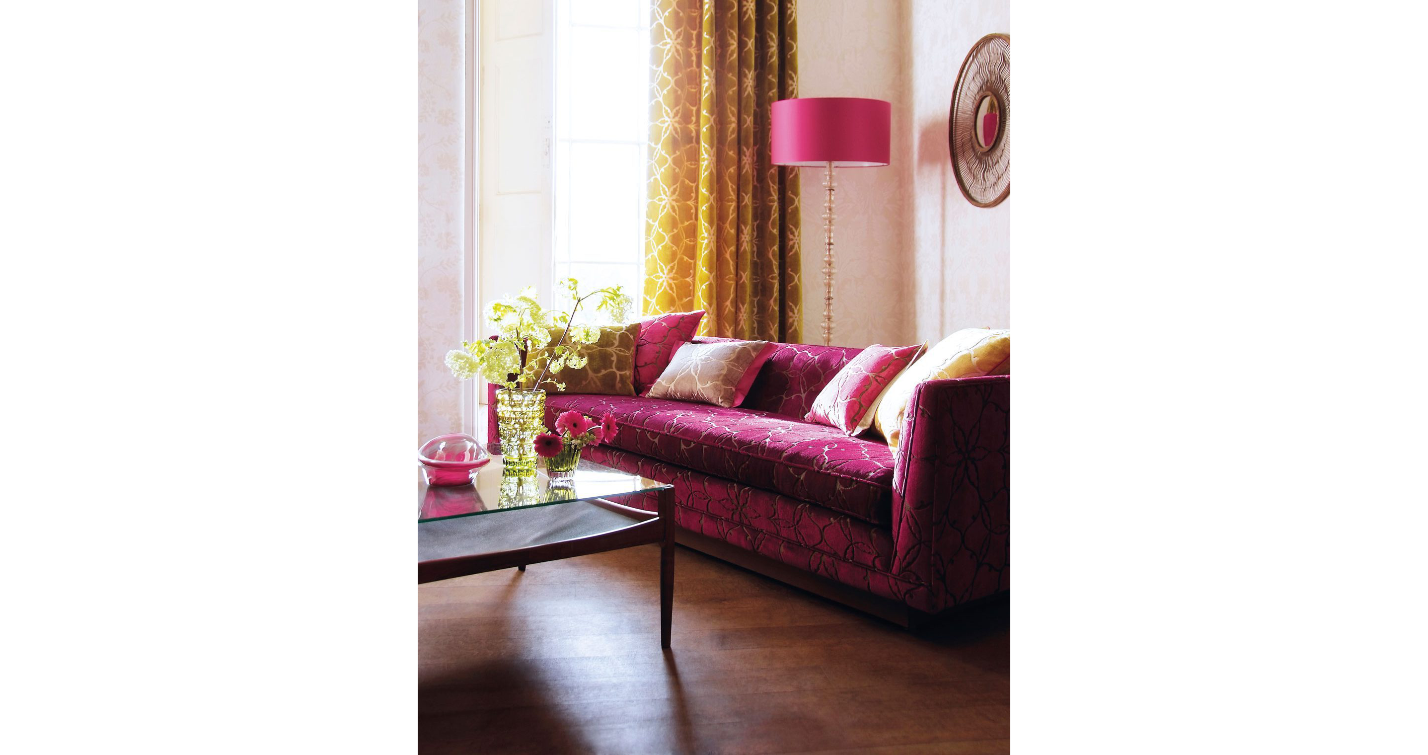 A living room featuring a beetroot colored couch.