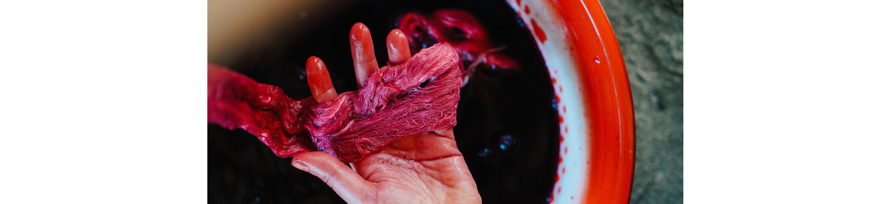 A person holding dyed threads.