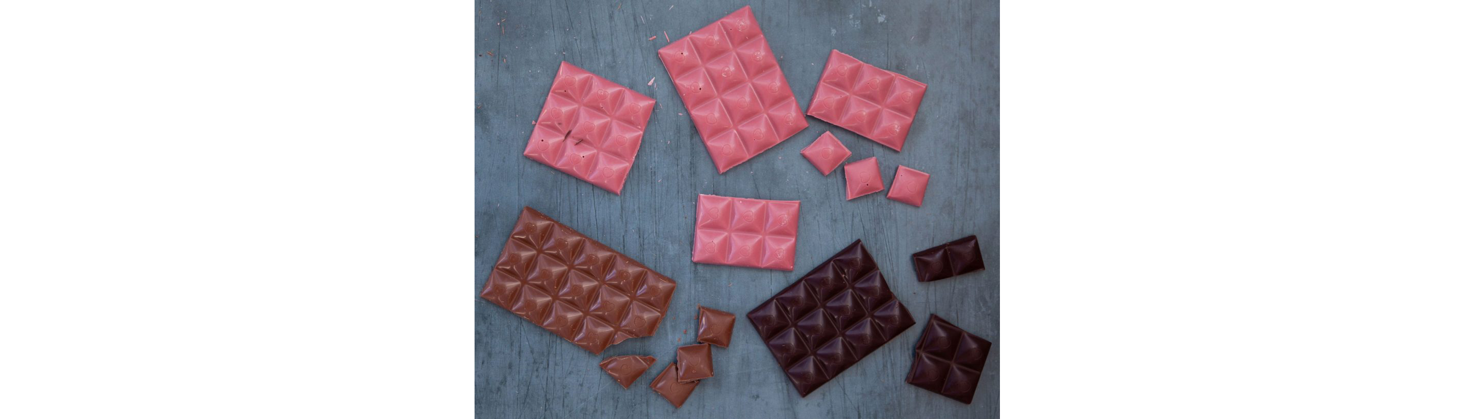 Decorated bars of ruby, dark and milk chocolate.
