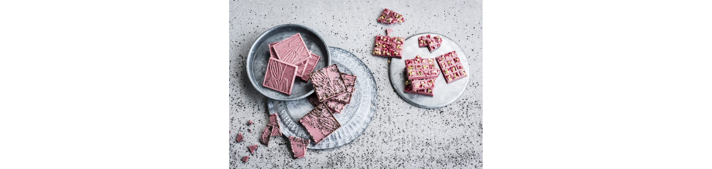Plates of ruby chocolate squares.