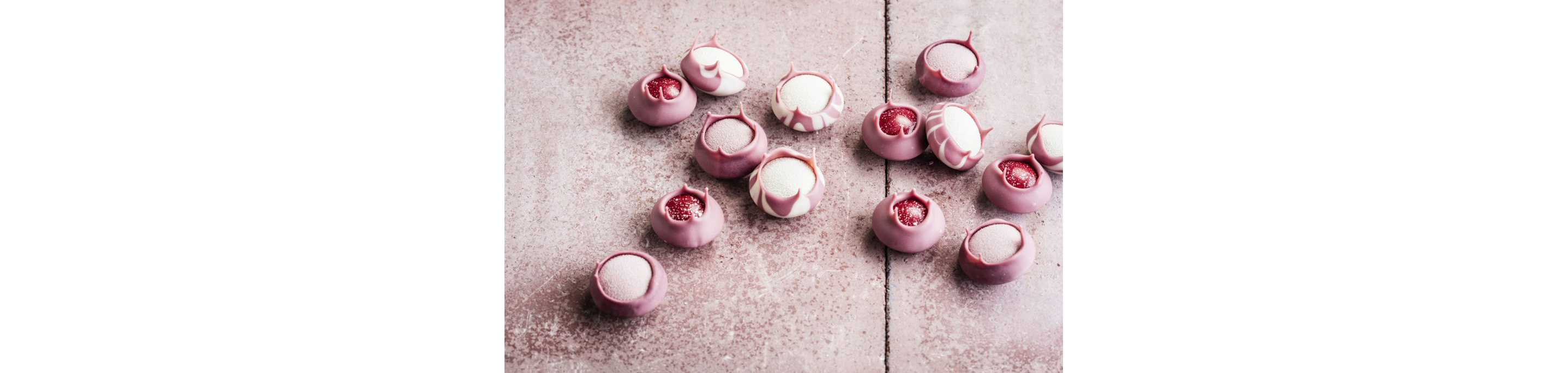 A table of delicate ruby chocolate candies.