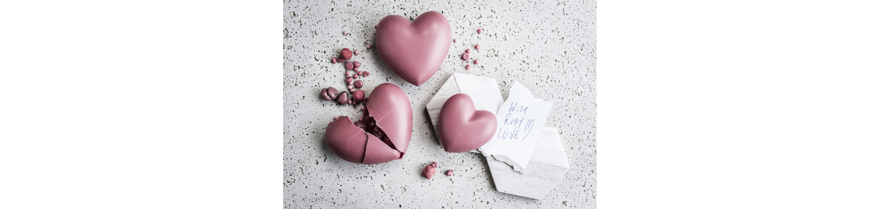 A table of ruby chocolate hearts.