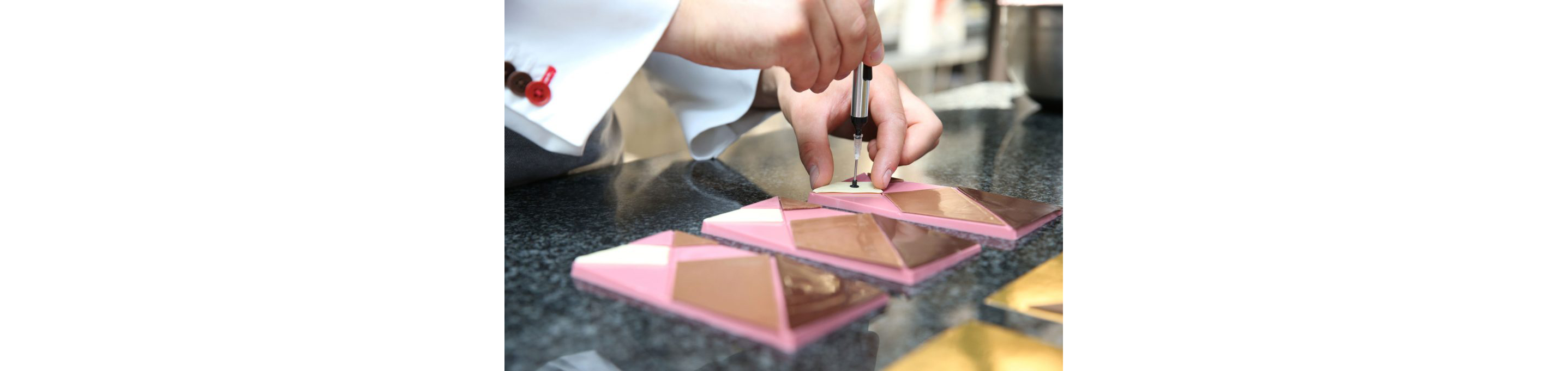 A chef putting together a four-chocolate bar.