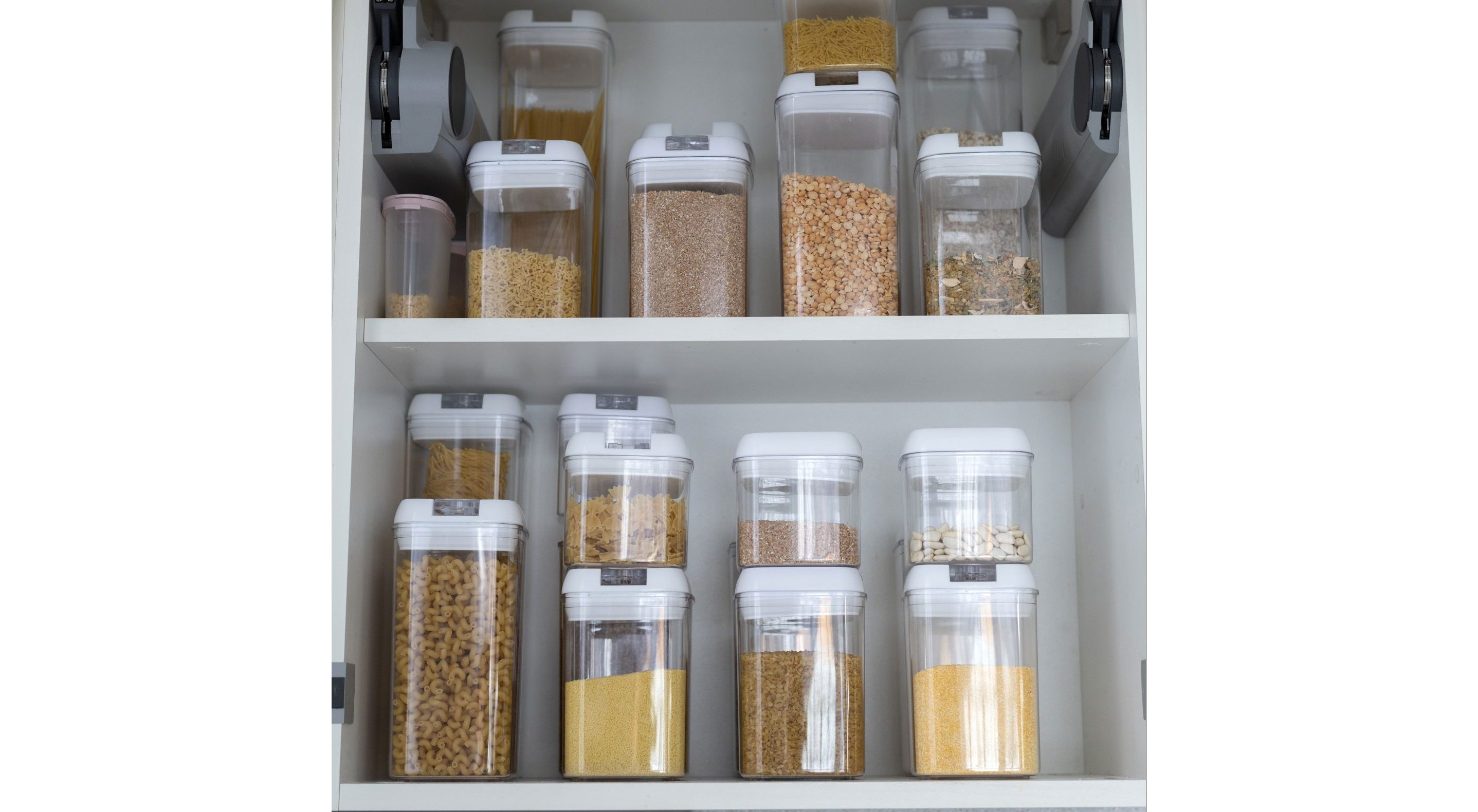 Organized containers of dried pastas and grain.