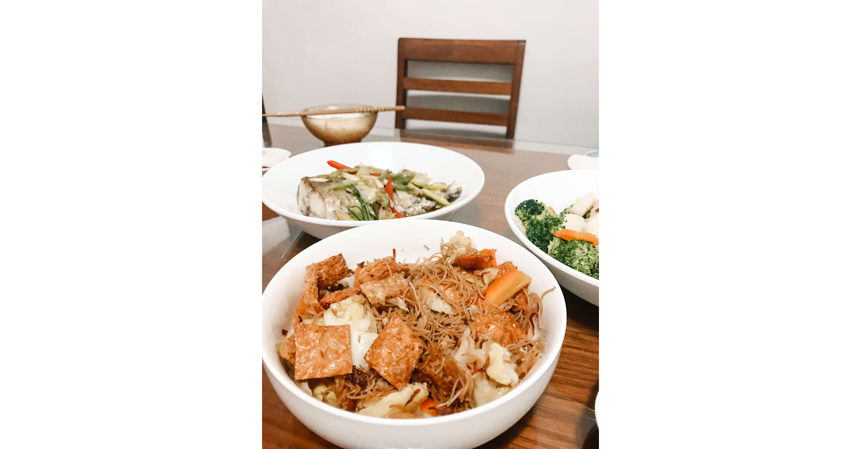 Three large serving dishes filled to the brim with food.