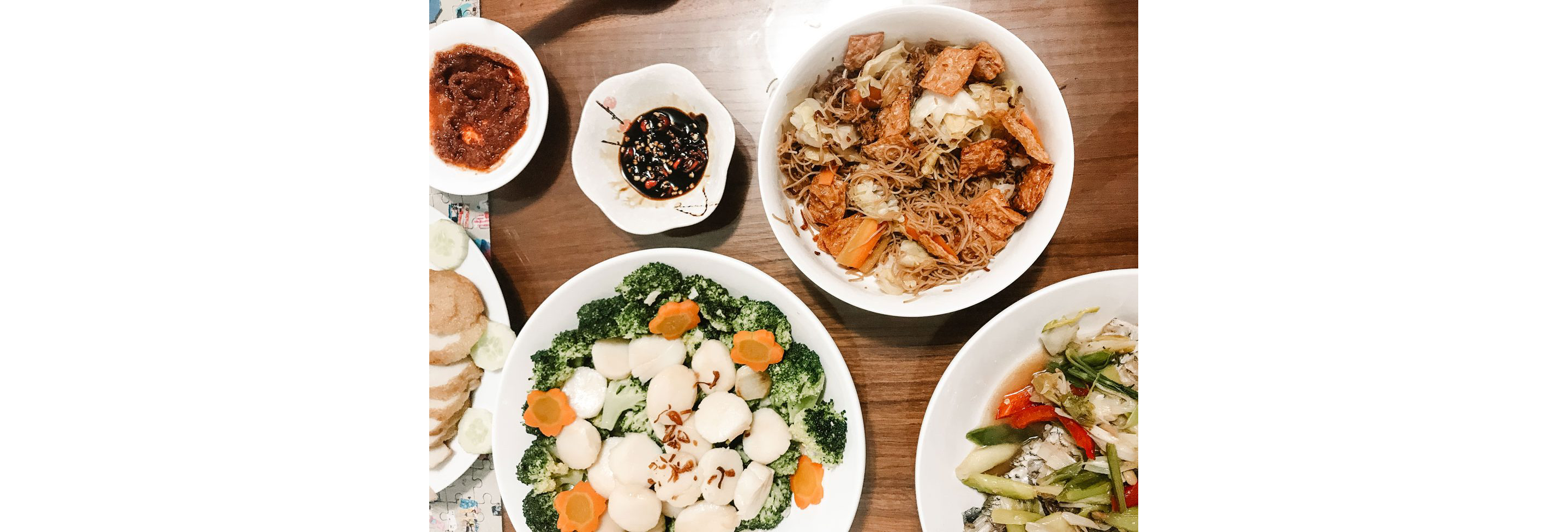 A dinner table with a variety of home cooked dishes.