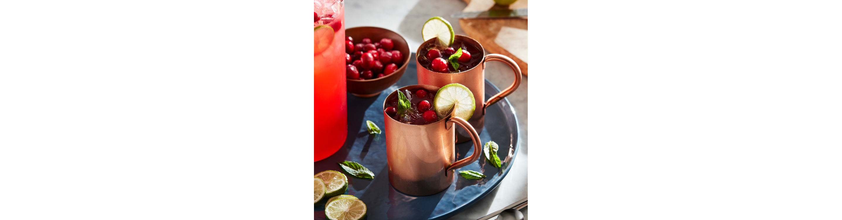 A set of Moscow Mule cocktails in their signature copper mugs.