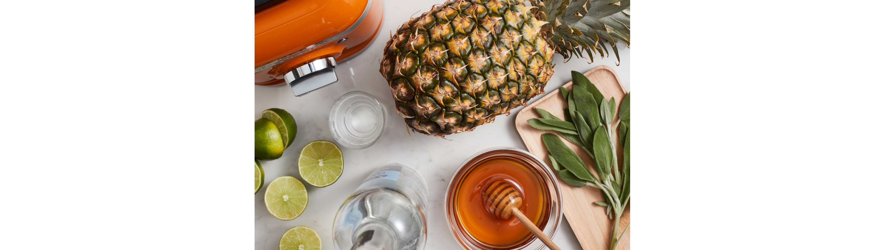 A series of ingredients, including a pineapple, honey and various herbs.
