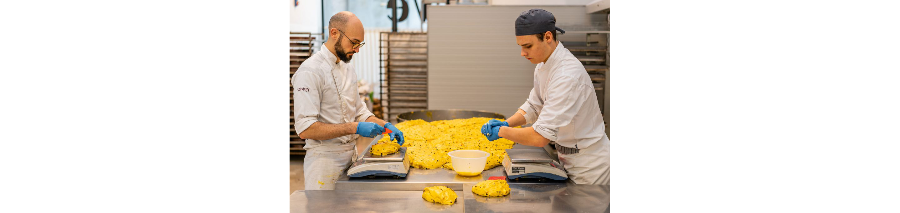 Bakers carefully portioning panettone dough.